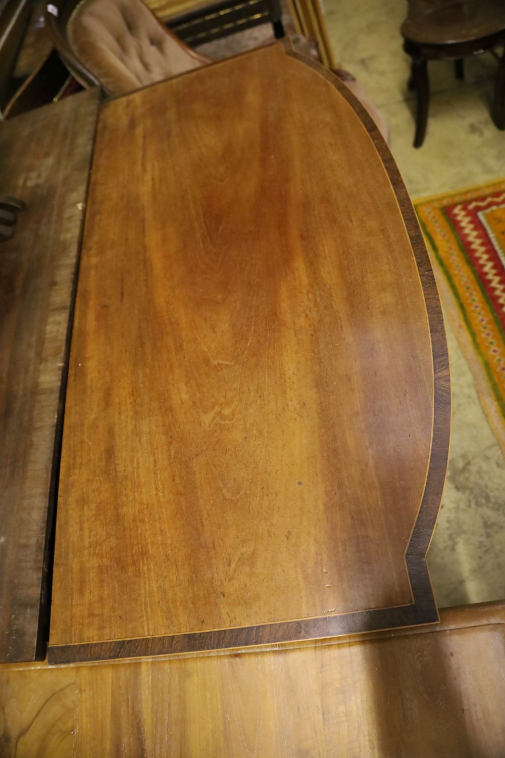 A Regency rosewood banded mahogany bow front sideboard, width 108cm, depth 53cm, height 92cm